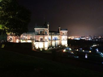 High angle view of illuminated buildings against sky at night