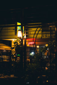 Illuminated sign on street in city at night