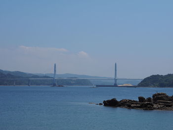 Bridge over sea against sky