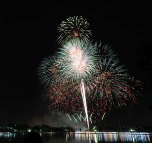 Low angle view of firework display at night