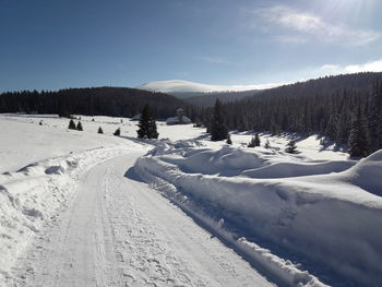 Snow covered landscape against sky