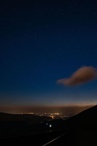 Aerial view of illuminated landscape against sky at night