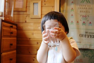 Close-up of boy holding drinking glass