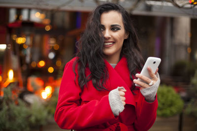 Portrait of young woman using smart phone outdoors