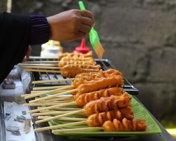 Cropped hand of person preparing food