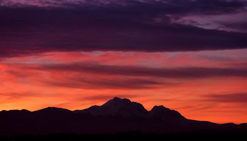 View of mountain against cloudy sky during sunset