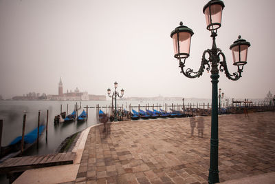 Scenic view of foggy harbor with traces of people