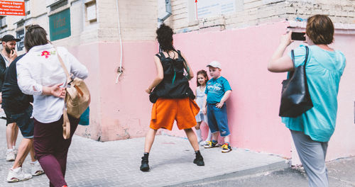 Group of people photographing building