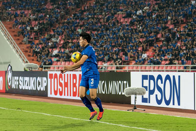 Woman standing on soccer field