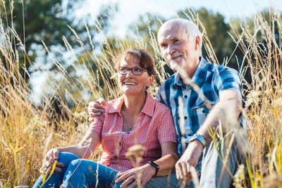 Senior couple sitting on field