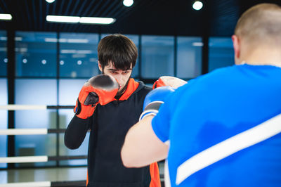 Men practicing in boxing ring