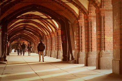 Rear view of people walking on oberbaum bridge