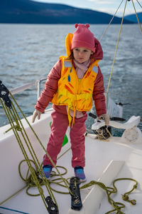 Portrait of boy standing on sea
