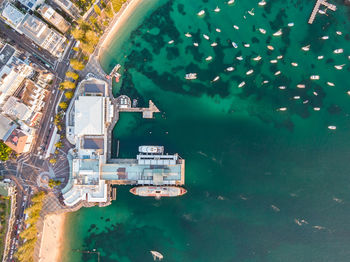 High angle view of buildings by sea in city