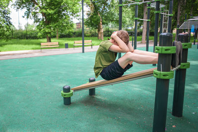 Full length of man exercising on field