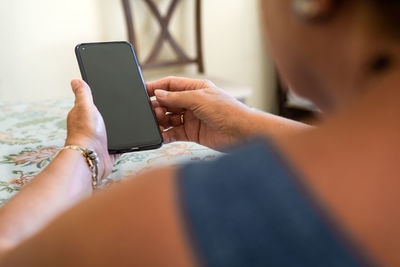 Midsection of woman using mobile phone