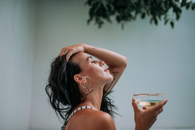 Close-up portrait of a woman drinking glass