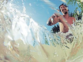 Underwater view of a happy young man