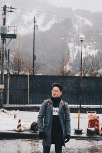 Portrait of young man standing in winter