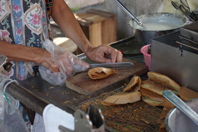 Midsection of woman preparing food in kitchen