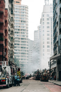 Cars on street amidst buildings in city