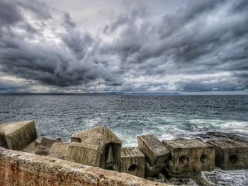 Scenic view of sea against storm clouds