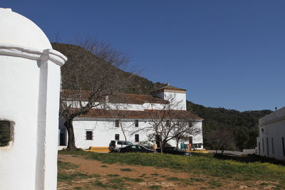 House on field against clear sky