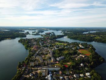 High angle view of townscape by sea against sky