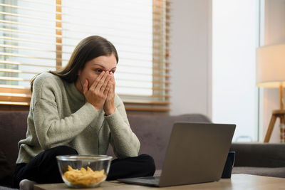 Young woman using laptop on table