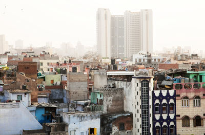 Cityscape against sky during foggy weather