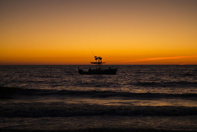 Scenic view of sea against orange sky