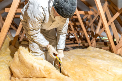 Rear view of man working at construction site