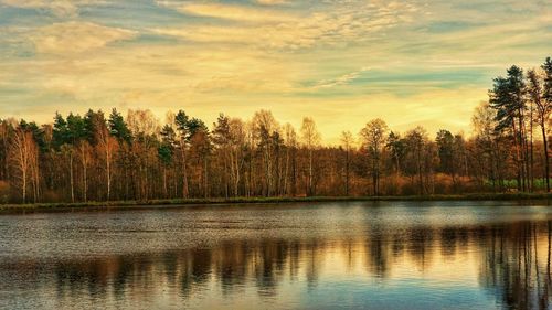 Scenic view of lake against sky at sunset