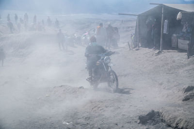 Man riding motorcycle on field