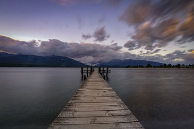 Pier over lake against sky during sunset in te anau, southland, new zealand