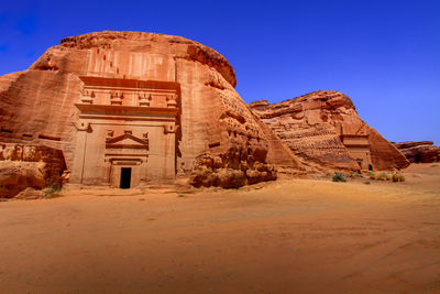 Rock formations in desert against clear blue sky