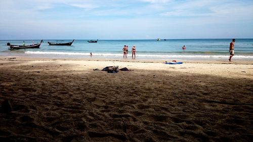 People on beach against sky
