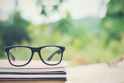 Close-up of eyeglasses on books outdoors