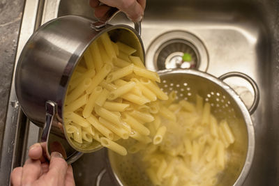 Midsection of person preparing food in kitchen