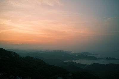 Scenic view of silhouette mountains against sky during sunset