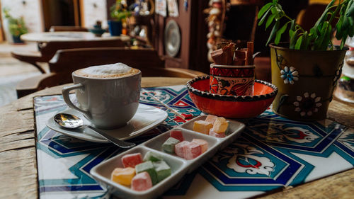 A coffee with turkish delights on colorful table in unique cozy cafe with beautiful decor in turkey.