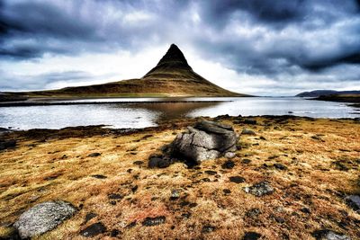 Scenic view of rocks on beach against sky