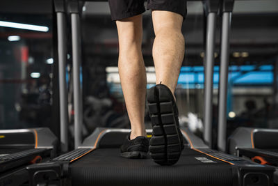 Low section of man wearing shoes