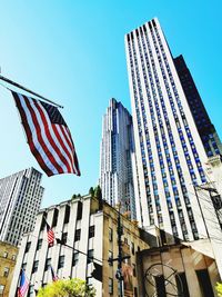 Low angle view of modern buildings against clear blue sky