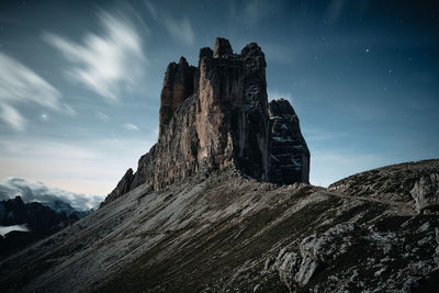 Low angle view of rock formation against sky