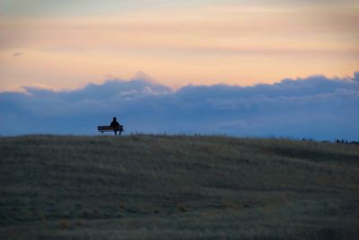 Scenic view of field against sky at sunset