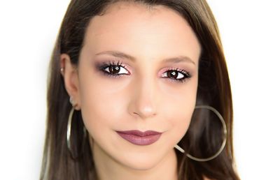 Close-up portrait of a beautiful young woman over white background