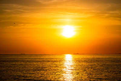 Scenic view of sea against romantic sky at sunset