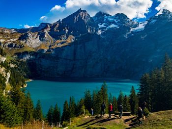 Scenic view of trees and mountains against sky