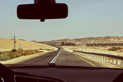 Road seen through car windshield
